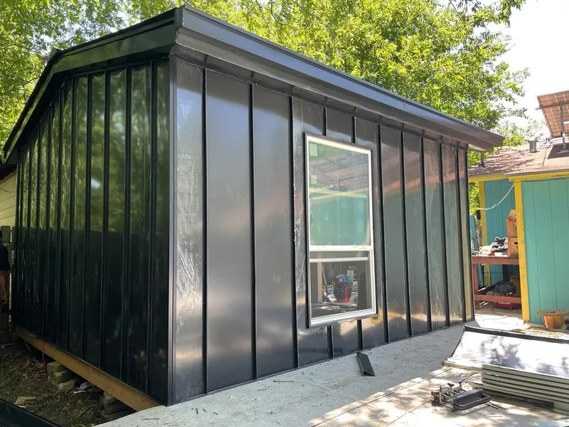 Black standing seam metal wall panels for Roof Inspection in Parlier